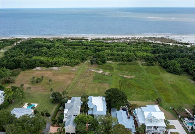 drone / aerial view featuring a water view and a view of the beach