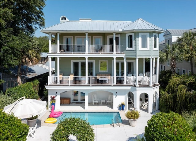 back of house featuring a patio area and a balcony