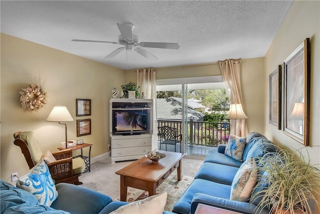 living room with a textured ceiling, ceiling fan, and light carpet