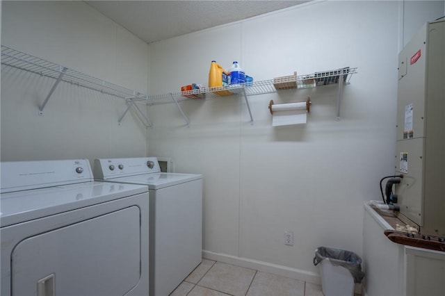 4068 3r Fish Camp Rd, White Oak, GA 31568 - clothes washing area featuring washing machine and clothes dryer, light tile patterned flooring, and heating unit