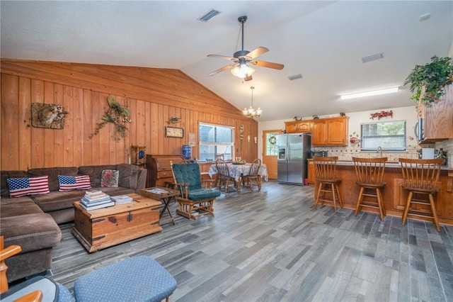 4068 3r Fish Camp Rd, White Oak, GA 31568 - living area featuring wooden walls, healthy amount of natural light, vaulted ceiling, ceiling fan, and wood finished floors