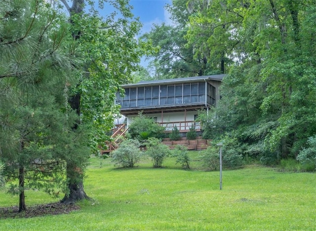 4068 3r Fish Camp Rd, White Oak, GA 31568 - view of front facade with a sunroom and a front yard