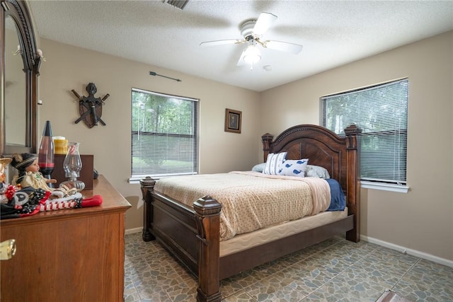 4068 3r Fish Camp Rd, White Oak, GA 31568 - bedroom with ceiling fan, baseboards, and a textured ceiling