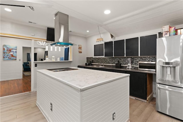 kitchen featuring decorative backsplash, light hardwood / wood-style floors, ornamental molding, appliances with stainless steel finishes, and island range hood