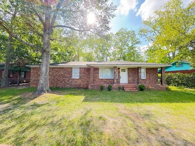 ranch-style house with brick siding and a front lawn