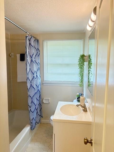 bathroom with shower / bath combo, vanity, toilet, a textured ceiling, and tile patterned floors