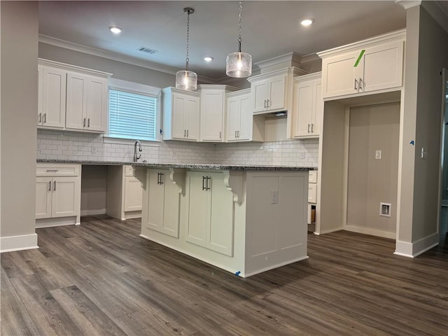193 W Melody Dr, Jesup, GA 31545 - kitchen with dark wood finished floors, backsplash, ornamental molding, white cabinets, and stone counters