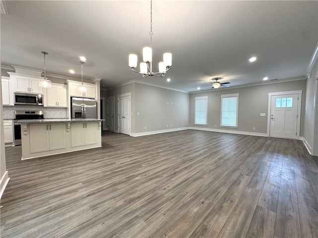 193 W Melody Dr, Jesup, GA 31545 - kitchen with stainless steel appliances, ornamental molding, open floor plan, a ceiling fan, and tasteful backsplash