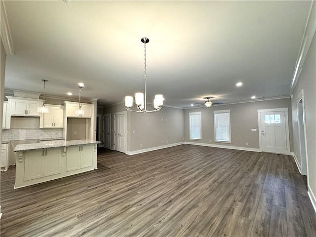 193 W Melody Dr, Jesup, GA 31545 - unfurnished living room featuring crown molding, dark wood-style floors, ceiling fan, recessed lighting, and a chandelier
