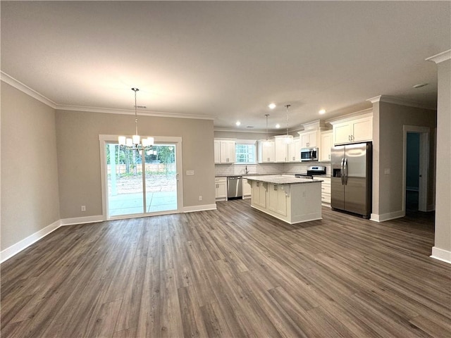 193 W Melody Dr, Jesup, GA 31545 - kitchen with stainless steel appliances, dark wood-type flooring, a kitchen island, white cabinetry, and a chandelier