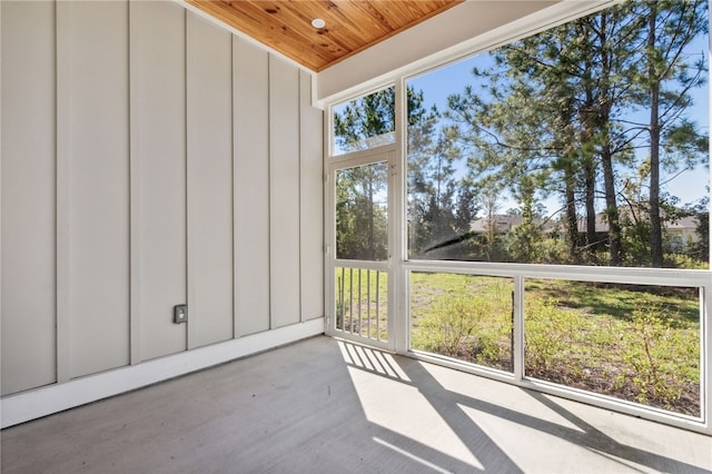 unfurnished sunroom with plenty of natural light and wood ceiling