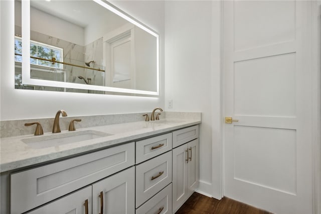 bathroom featuring vanity, wood-type flooring, and walk in shower