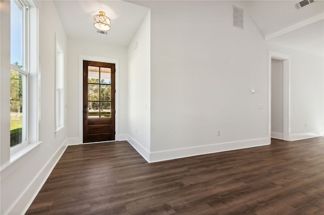 entryway with vaulted ceiling and dark wood-type flooring