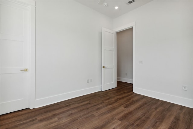 spare room featuring dark wood-type flooring