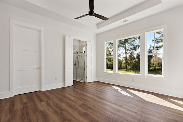 unfurnished bedroom with dark hardwood / wood-style flooring, ensuite bath, and ceiling fan