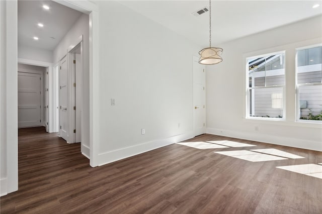 spare room featuring dark hardwood / wood-style flooring