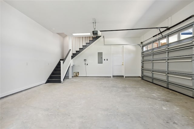 garage featuring electric panel and a garage door opener