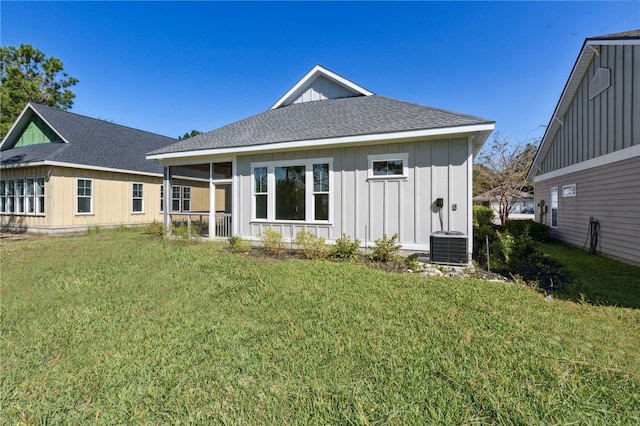 rear view of property with a yard