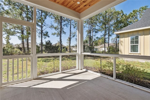 unfurnished sunroom featuring wooden ceiling