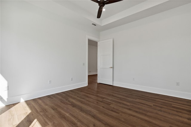 empty room with ceiling fan and dark wood-type flooring