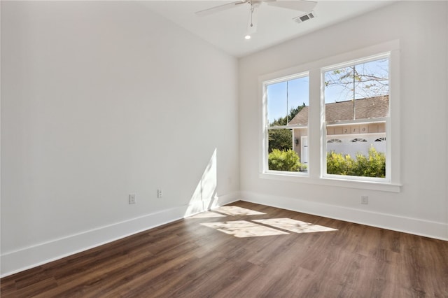 spare room featuring dark hardwood / wood-style flooring and ceiling fan