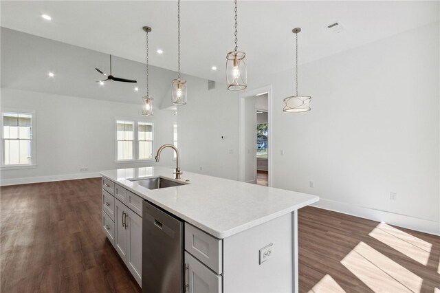 kitchen with dishwasher, plenty of natural light, sink, and an island with sink