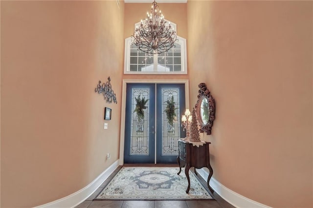 655 Littlefield St, Jesup, GA 31546 - foyer entrance featuring french doors, a chandelier, tile patterned flooring, and a high ceiling