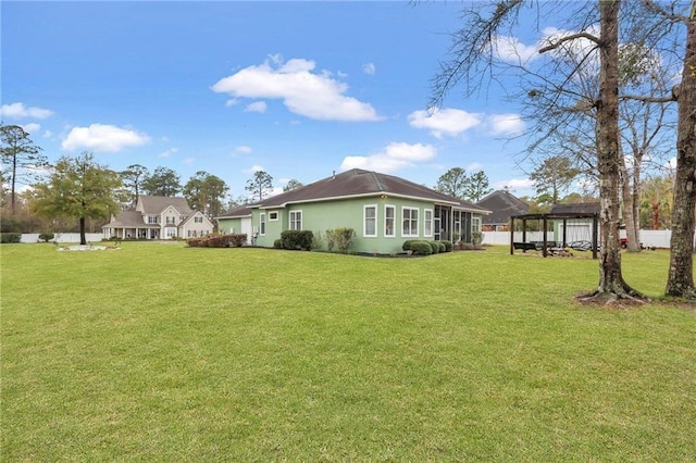 655 Littlefield St, Jesup, GA 31546 - back of house featuring a gazebo, a lawn, and stucco siding