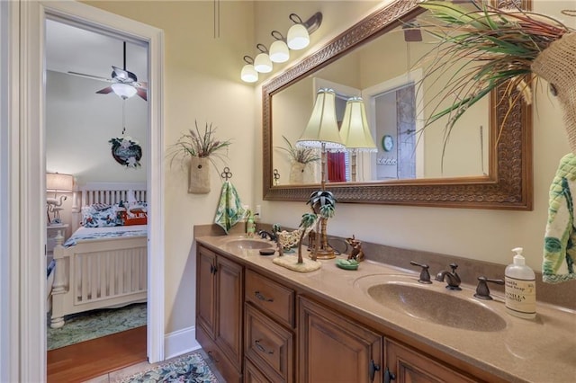 655 Littlefield St, Jesup, GA 31546 - bathroom with connected bathroom, double vanity, and a ceiling fan