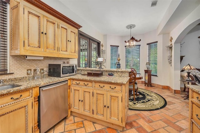 265 Harbor Pointe Dr, Brunswick, GA 31523 - kitchen featuring appliances with stainless steel finishes, backsplash, a peninsula, a chandelier, and baseboards