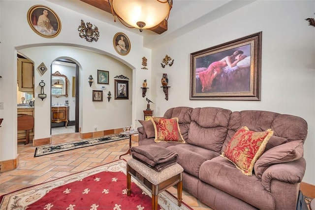 265 Harbor Pointe Dr, Brunswick, GA 31523 - living room with brick flooring, arched walkways, and baseboards
