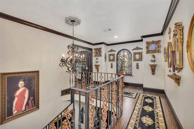 265 Harbor Pointe Dr, Brunswick, GA 31523 - hall featuring an upstairs landing, a chandelier, ornamental molding, wood finished floors, and baseboards