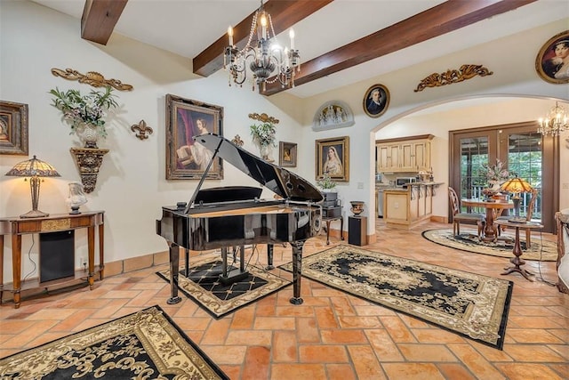 265 Harbor Pointe Dr, Brunswick, GA 31523 - living area featuring a chandelier, beamed ceiling, arched walkways, and baseboards