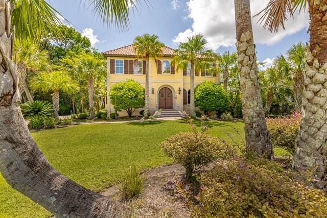 265 Harbor Pointe Dr, Brunswick, GA 31523 - mediterranean / spanish-style home featuring a front yard, stucco siding, and a tiled roof