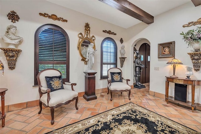 265 Harbor Pointe Dr, Brunswick, GA 31523 - sitting room with arched walkways, beamed ceiling, baseboards, and brick flooring