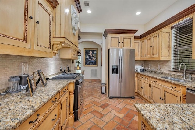 265 Harbor Pointe Dr, Brunswick, GA 31523 - kitchen featuring appliances with stainless steel finishes, a sink, backsplash, light stone countertops, and baseboards