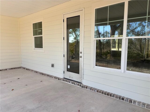 property entrance with a patio area