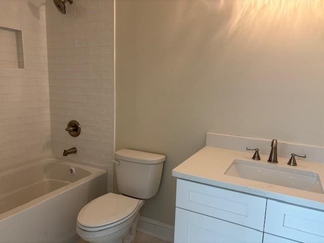 bathroom featuring baseboards, vanity, toilet, and shower / bathtub combination