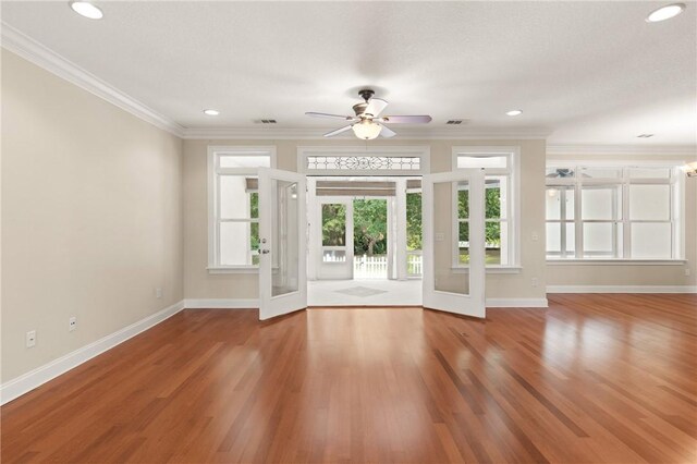 127 Clipper Bay Rd, Brunswick, GA 31523 - unfurnished living room featuring a ceiling fan, baseboards, wood finished floors, crown molding, and french doors
