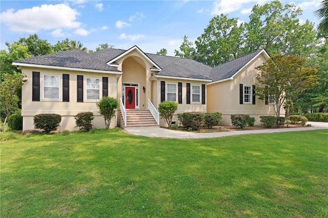 127 Clipper Bay Rd, Brunswick, GA 31523 - ranch-style house with a front yard, stucco siding, and a shingled roof