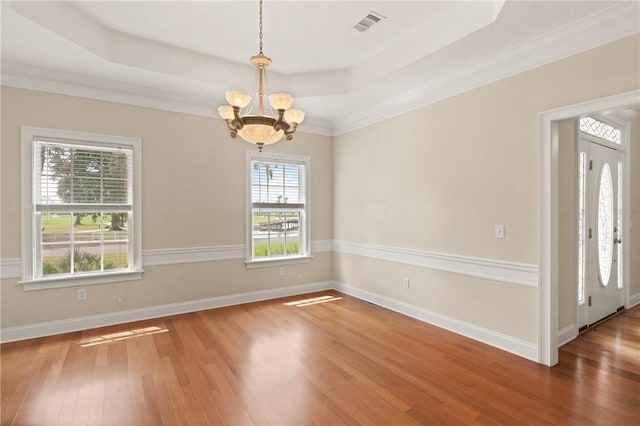 127 Clipper Bay Rd, Brunswick, GA 31523 - unfurnished room with a chandelier, wood finished floors, a tray ceiling, and crown molding