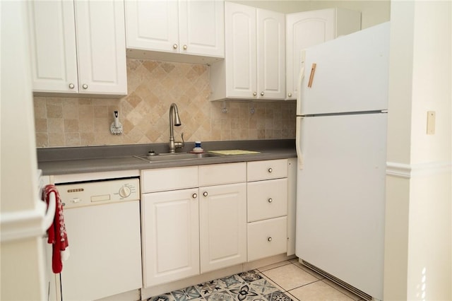 kitchen with white appliances, a sink, tasteful backsplash, and white cabinetry