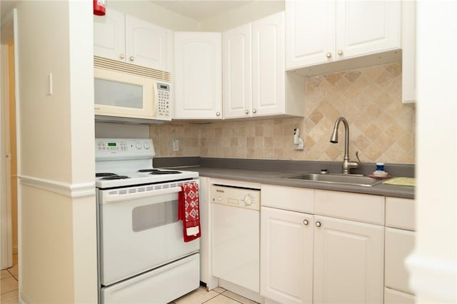 kitchen with white appliances, a sink, decorative backsplash, white cabinetry, and light tile patterned flooring