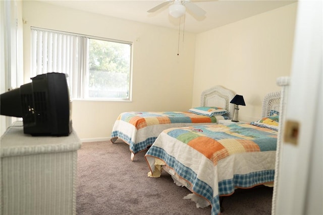 carpeted bedroom with baseboards and ceiling fan