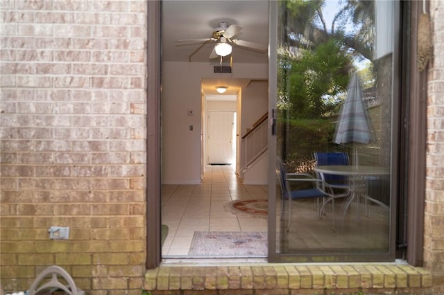 doorway to property with brick siding