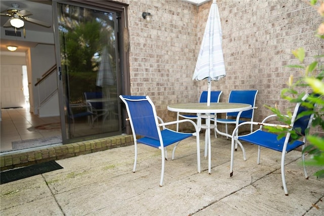 view of patio with outdoor dining area and ceiling fan