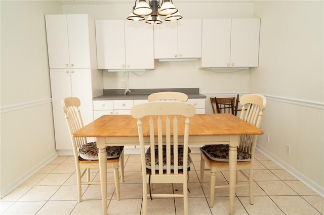 dining area featuring light tile patterned flooring and baseboards
