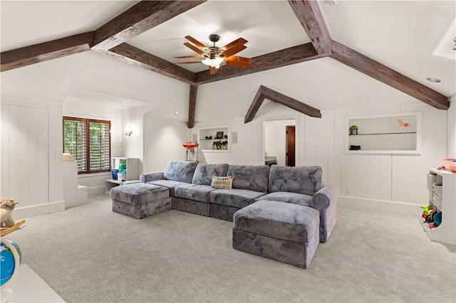 carpeted living area featuring ceiling fan, lofted ceiling with beams, and baseboards