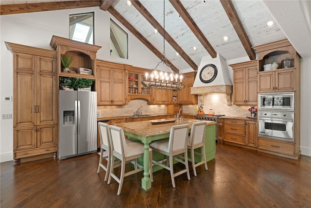 kitchen with a sink, stainless steel appliances, open shelves, and premium range hood
