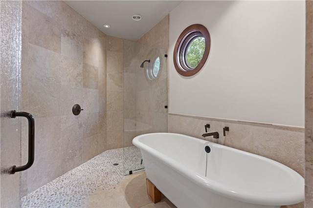 full bath featuring a soaking tub, recessed lighting, and a stall shower